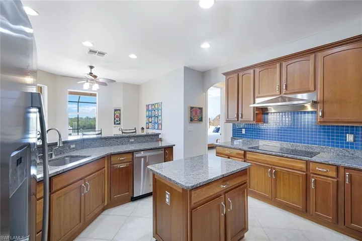 Beautiful kitchen with lots of cabinets, granite counter tops and walk-in pantry