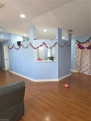 Living room with wood finished floors and recessed lighting