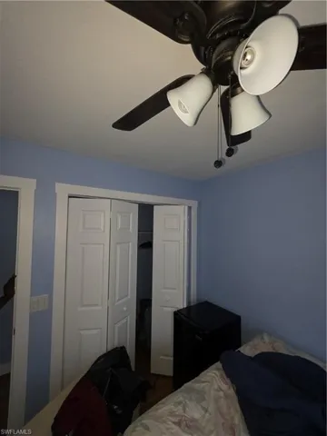 Bedroom with a closet and ceiling fan