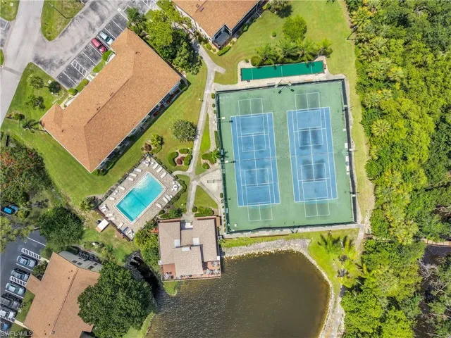 Community amenities featuring two tennis courts, an outdoor swimming pool, and dedicated parking areas