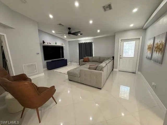 Living room featuring recessed lighting and a ceiling fan