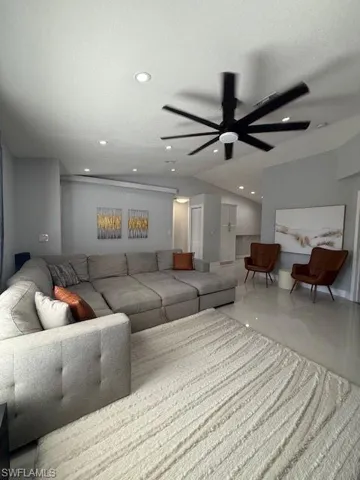 Living room with a ceiling fan and recessed lighting