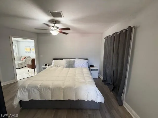 Bedroom featuring dark wood finished floors and a ceiling fan