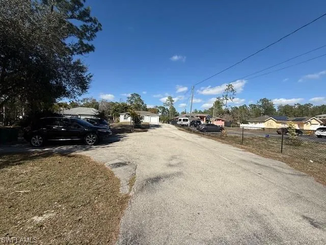 View of asphalt street featuring a residential view