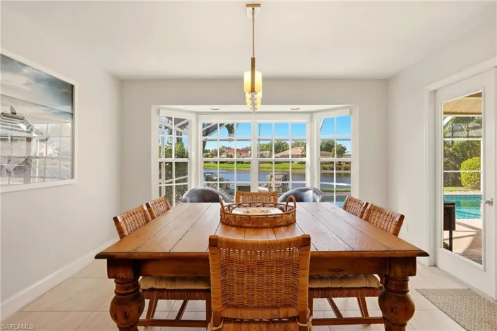 Dining room with a water view and baseboards