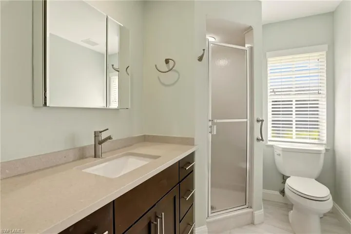Bathroom featuring a stall shower and vanity