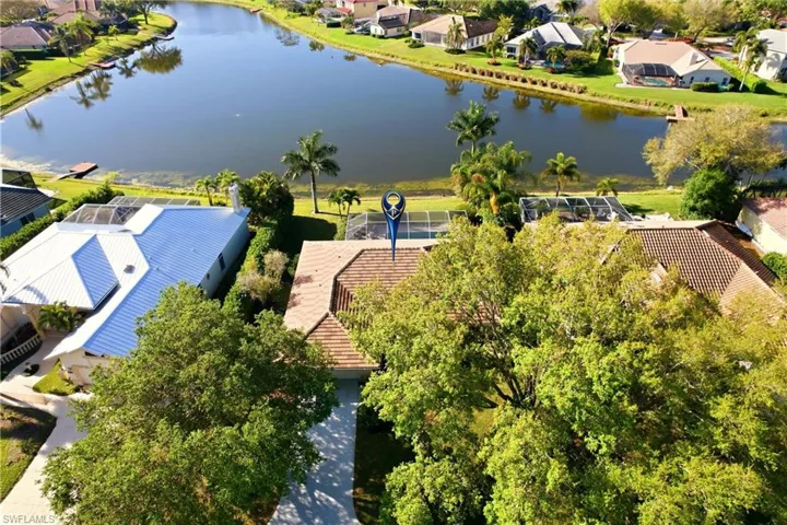 Aerial perspective of suburban area featuring a nearby body of water