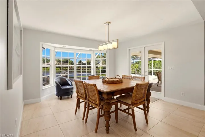 Dining room featuring french doors and light tile patterned floors