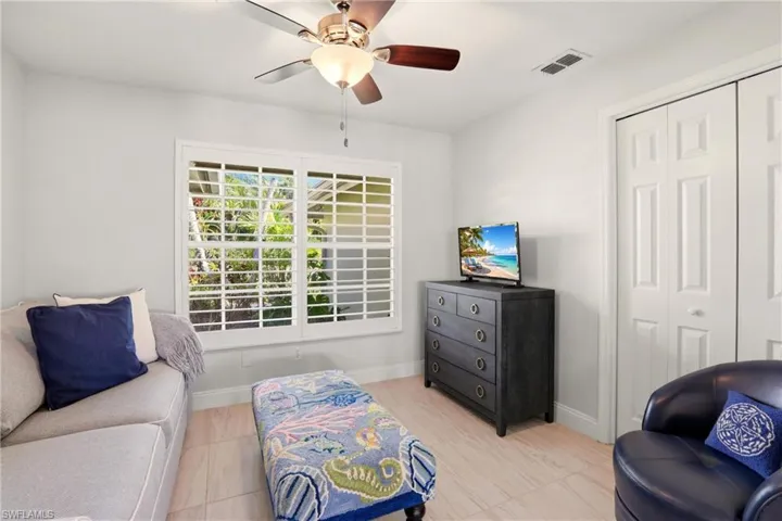 Sitting room featuring ceiling fan and baseboards