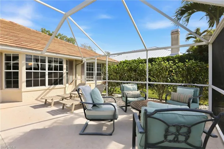 View of patio with a sunroom, a lanai, and outdoor furniture