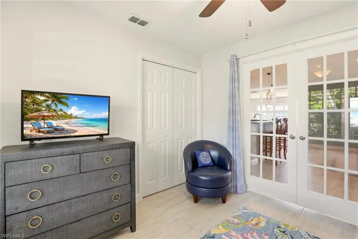 Living area with french doors and ceiling fan