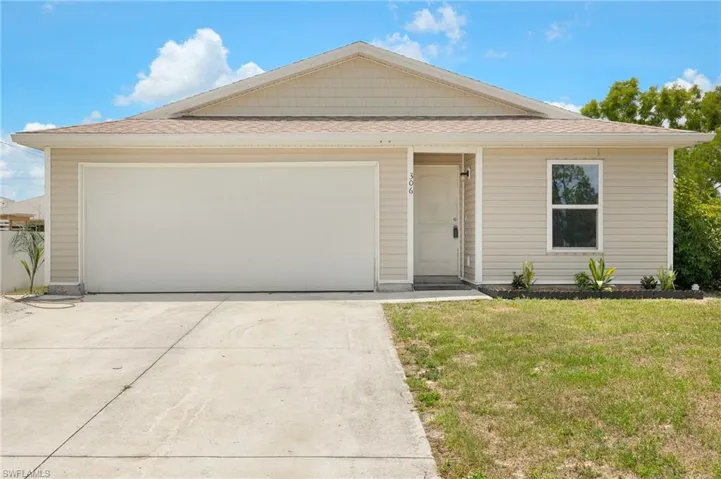 View of front facade with driveway, a front lawn, a shingled roof, and a garage