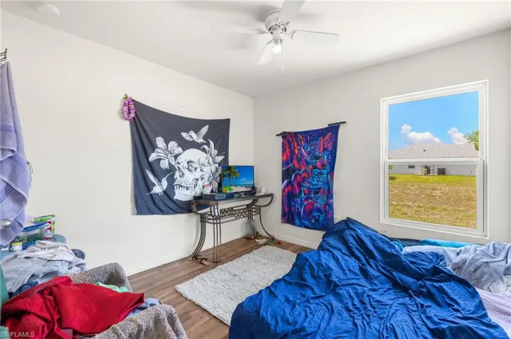Bedroom featuring wood finished floors, ceiling fan, and baseboards