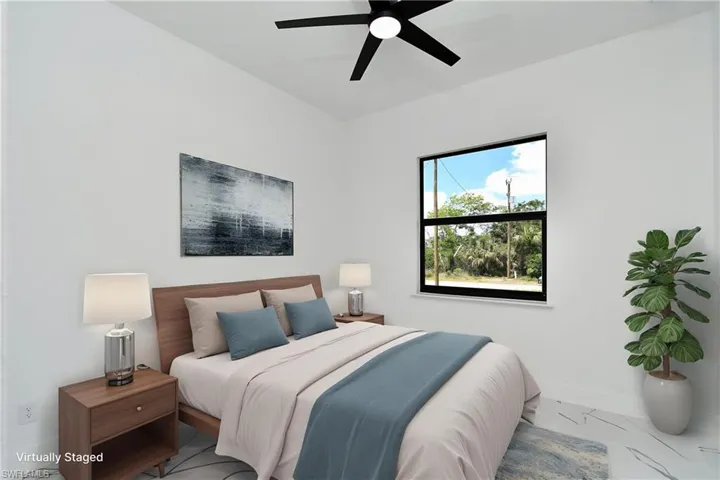 Bright room featuring a ceiling fan, a window with exterior views, and light-toned flooring