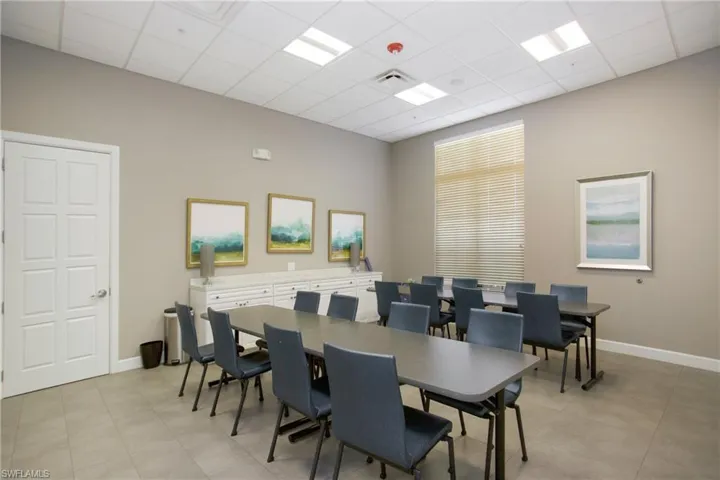 Dining space featuring a high drop ceiling and baseboards