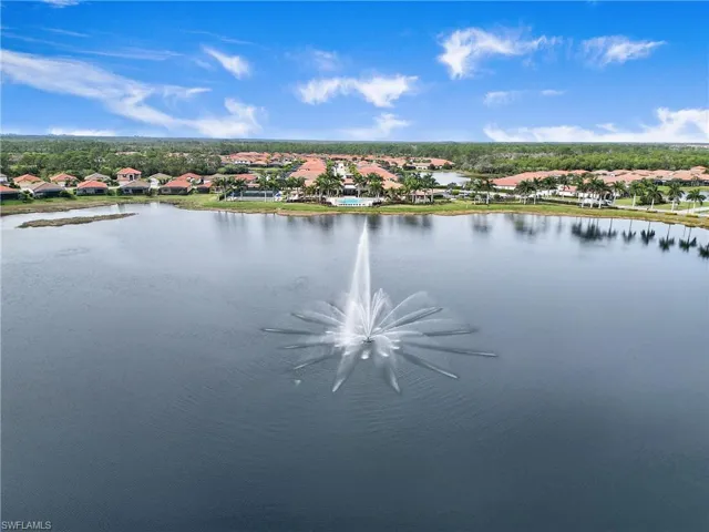 Aerial view of residential area featuring a nearby body of water