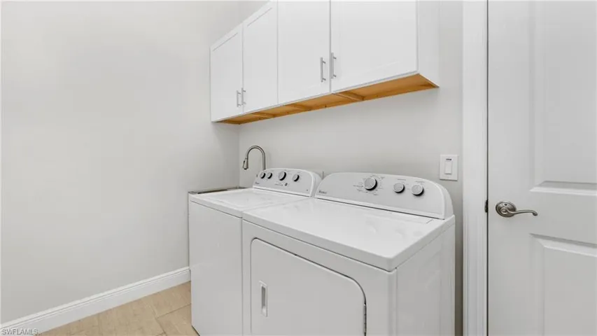 Laundry room featuring cabinet space and washing machine and clothes dryer