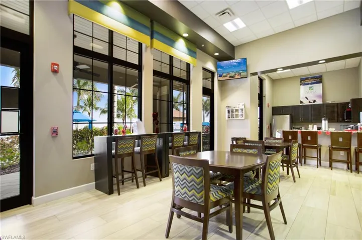 Dining area featuring a high drop ceiling and light wood-style flooring
