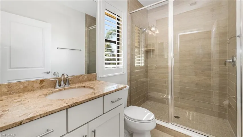Full bathroom featuring vanity and a stall shower