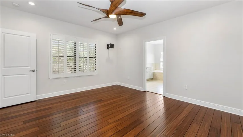 Unfurnished room featuring a ceiling fan, dark wood finished floors, and recessed lighting