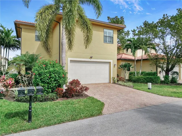 Mediterranean / spanish house featuring an attached garage, decorative driveway, stucco siding, and a tiled roof