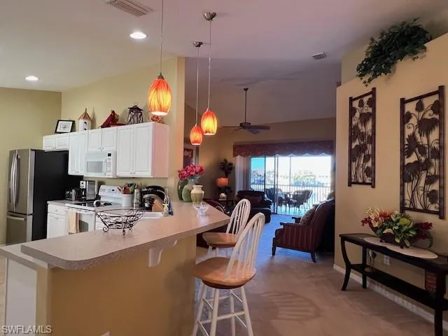 Kitchen with a breakfast bar and an open floor plan
