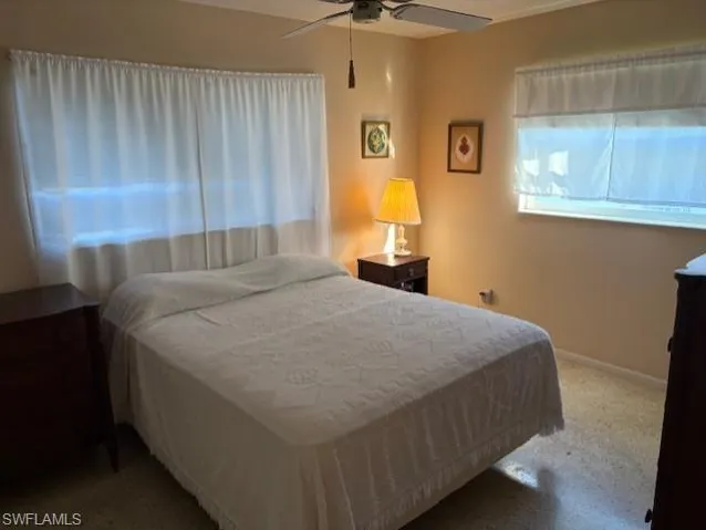 Bedroom featuring a ceiling fan and carpet