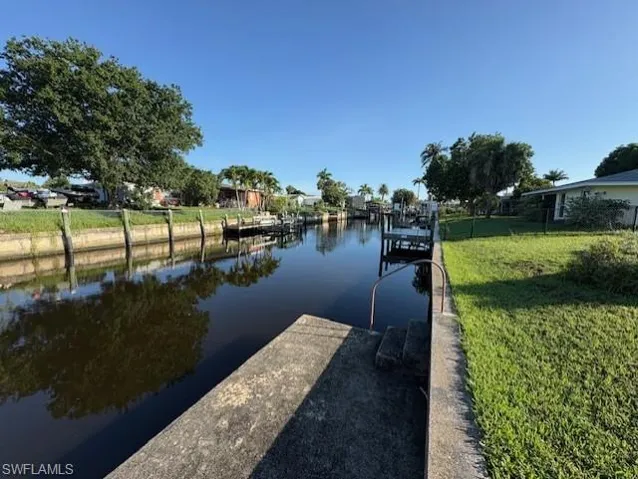 Dock with a yard and a water view