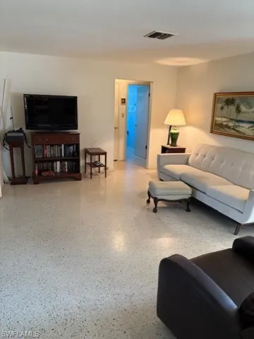 Living area featuring speckle patterned floor
