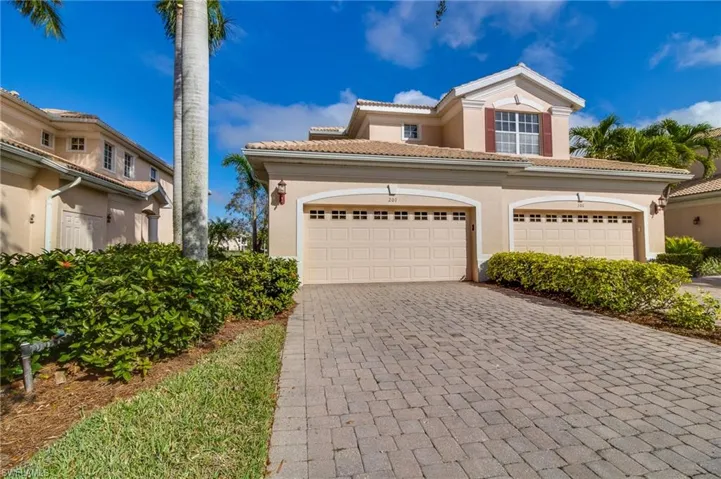 Mediterranean / spanish-style house with stucco siding, decorative driveway, and a tiled roof