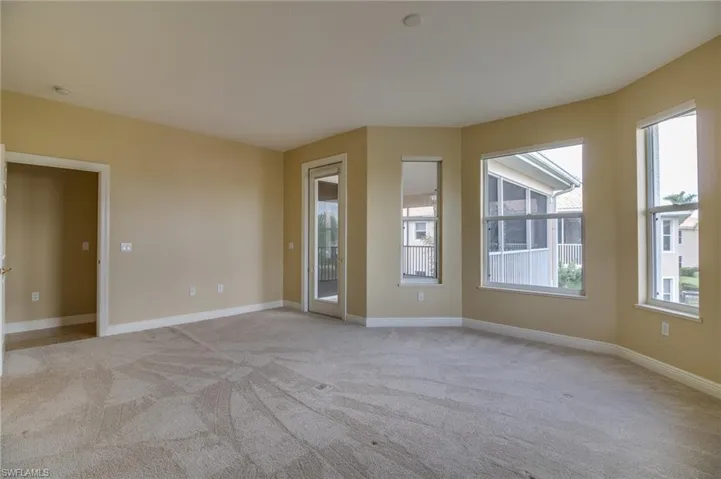 Unfurnished room with light carpet and baseboards