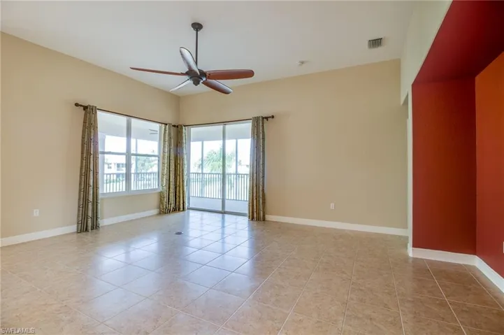 Spare room featuring light tile patterned floors and ceiling fan