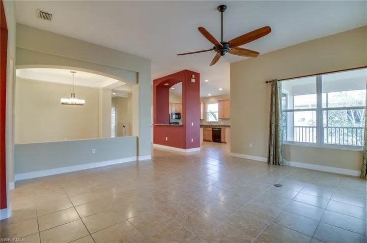 Unfurnished living room with a ceiling fan, light tile patterned floors, and recessed lighting