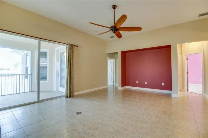 Spare room featuring ceiling fan and light tile patterned flooring