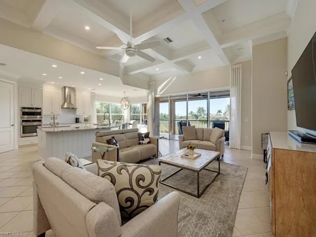 Great room, with architectural ceiling detailing, opening to kitchen and lanai