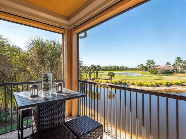 Balcony with a water view and golf course view