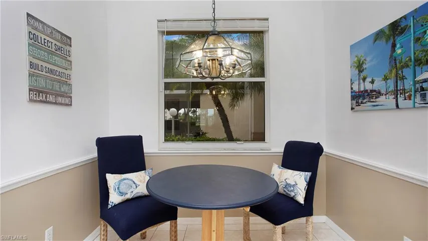 Tiled dining room featuring a notable chandelier
