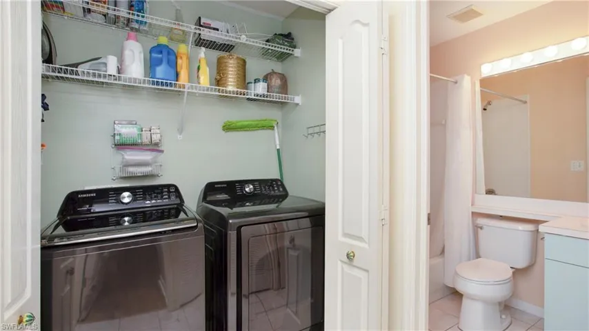Laundry area featuring separate washer and dryer and tile patterned floors
