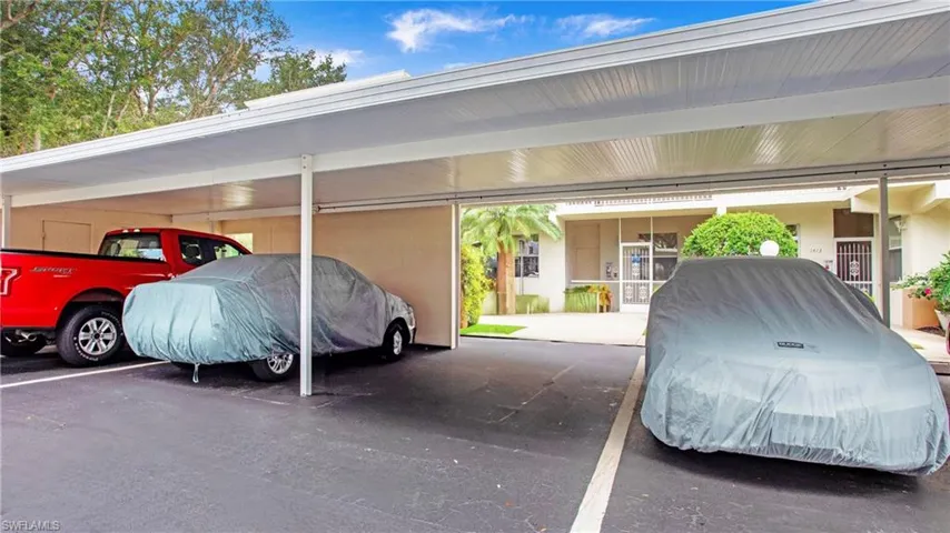 View of car parking featuring a carport