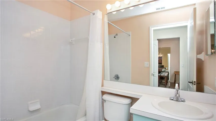 Full bathroom featuring shower / bath combo, toilet, and vanity