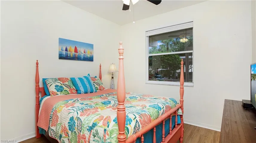 Bedroom with ceiling fan and wood-type flooring