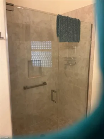 Full bathroom with a shower stall