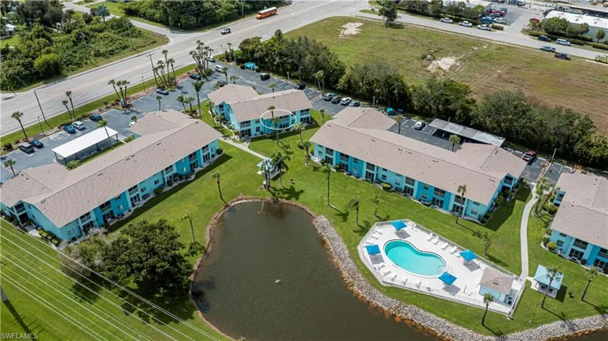 Aerial view of a pool and a nearby body of water