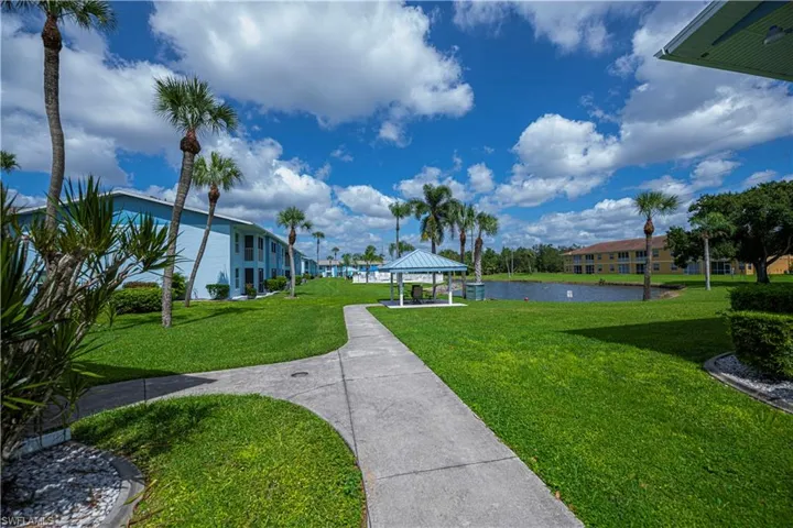 View of community with a gazebo, a water view, a yard, and a patio
