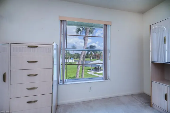 Unfurnished dining area featuring a water view and light carpet
