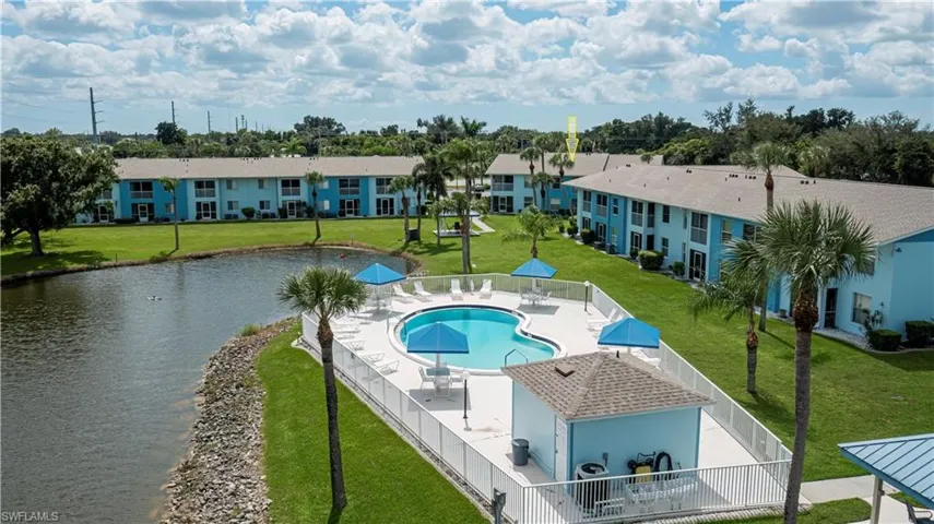 Community pool with a patio and a water view