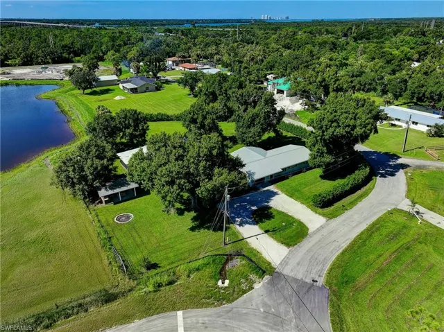 Birds eye view of property with a water view