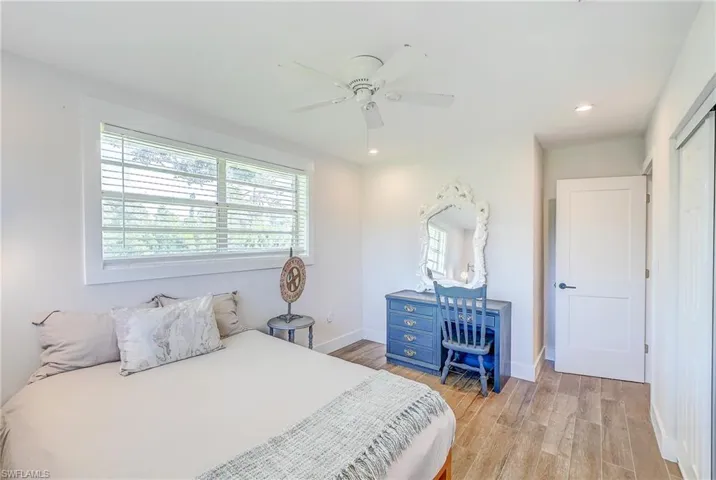 Bedroom with ceiling fan and light wood-type flooring