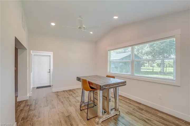 Dining area with ceiling fan, vaulted ceiling, and plenty of natural light
