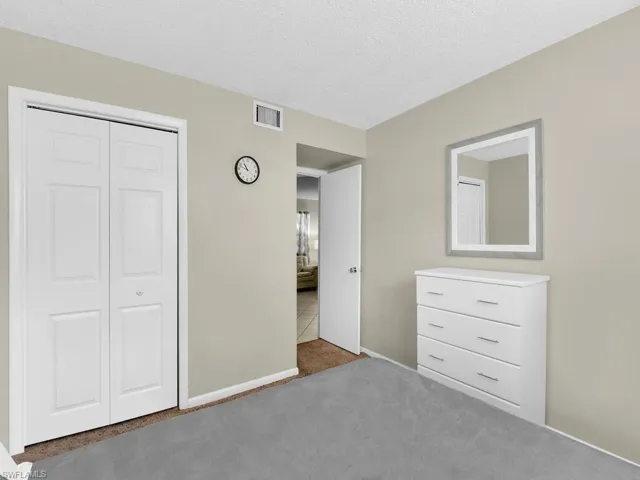 Unfurnished bedroom featuring carpet flooring, a closet, and a textured ceiling